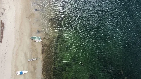 Boats and a sandy shoreline in Lamu County, Kenya